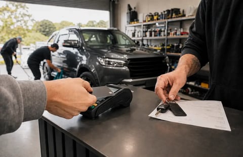 EFTPOS card payment being processed at an automotive workshop counter